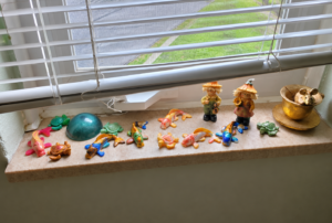Handmade epoxy resin art: glossy koi fish, turtles and a teal resin dome on a window ledge